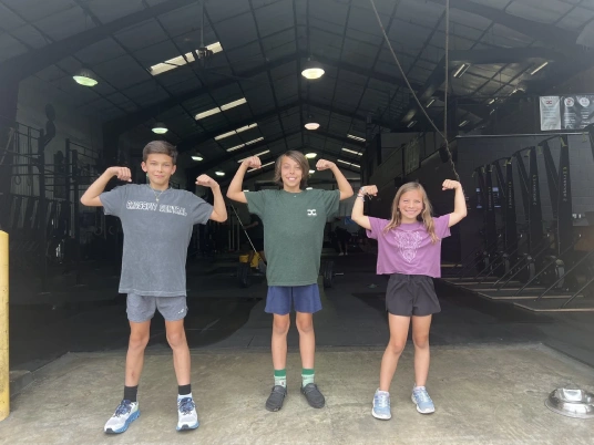 Kids flexing at Koda Central strength camp